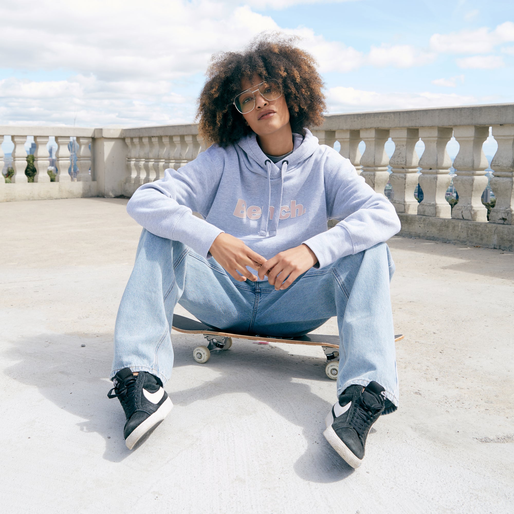 girl sitting on skateboard outdoors