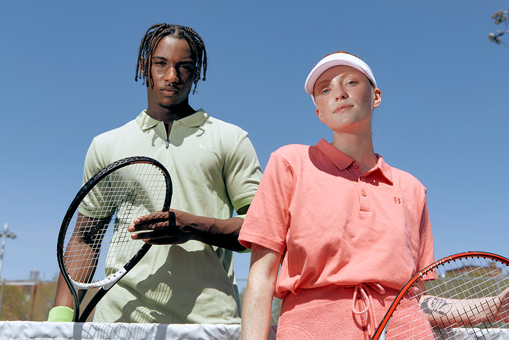 man and women outdoors with tennis rackets